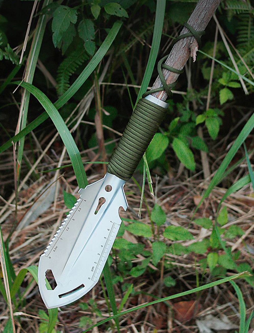 Outdoor shovel with spear tip in the grass